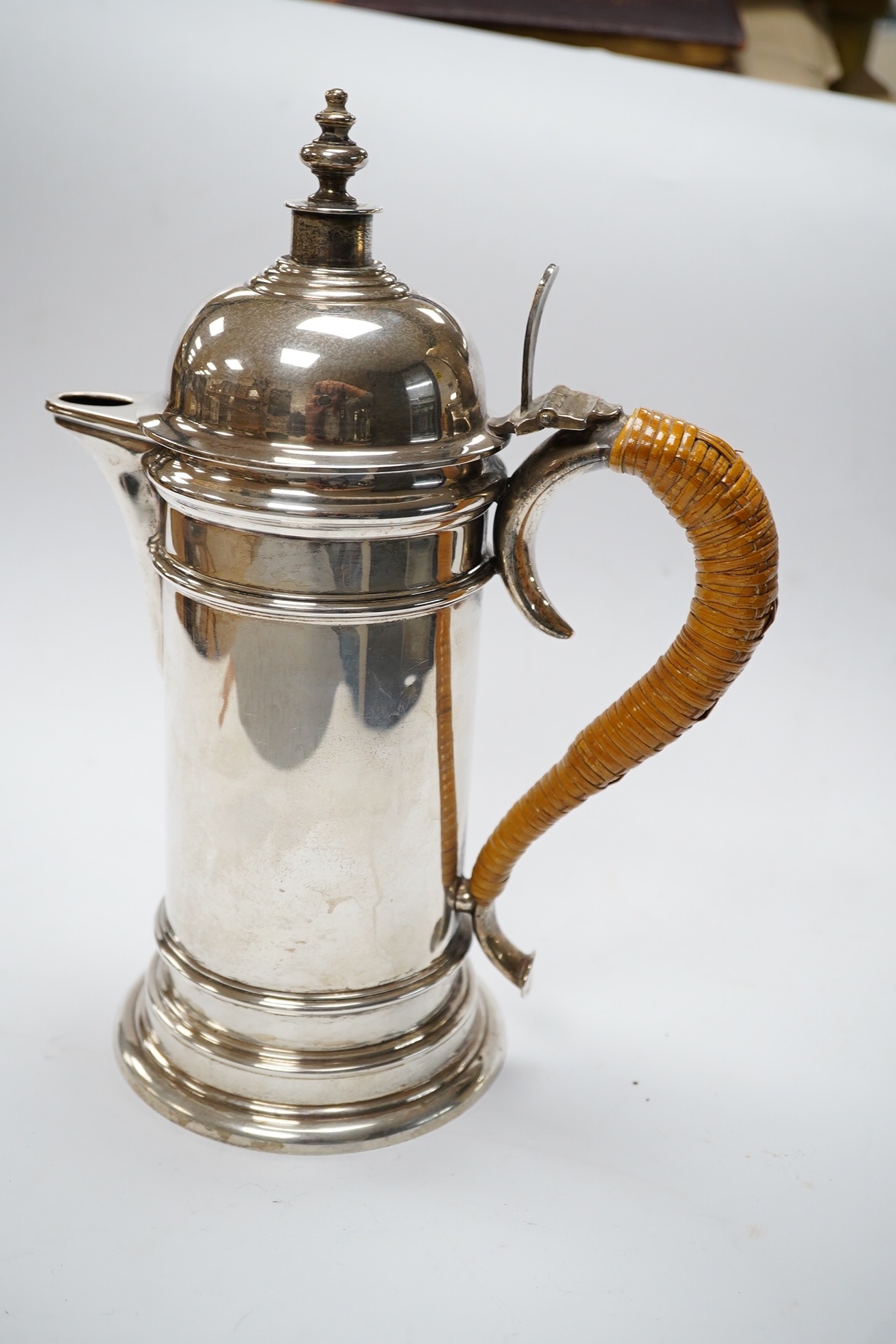 A George V silver cylindrical coffee pot, with a wicker handle, Birmingham, 1917 by Elkington & Co, 25.6cm, gross weight 23.1oz. Condition - fair